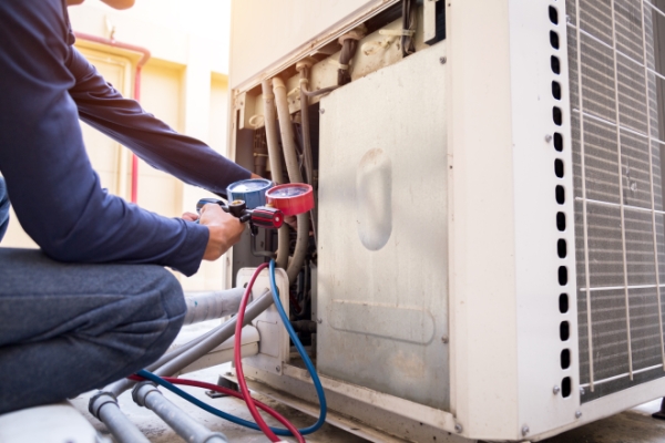 air conditioner technician measuring equipment