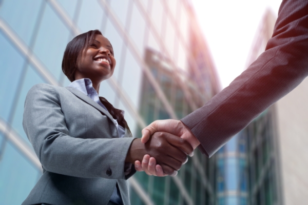 young black business woman shaking hands with business man