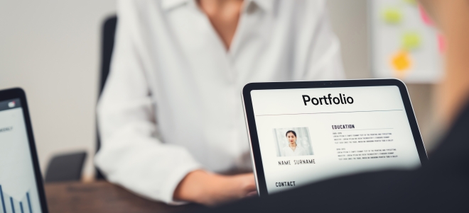 Woman having her portfolio reviewed on a laptop 